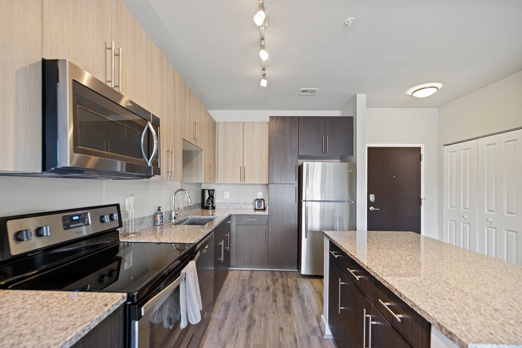 a kitchen with granite countertops and stainless steel appliances at Rivergate, Woodbridge
