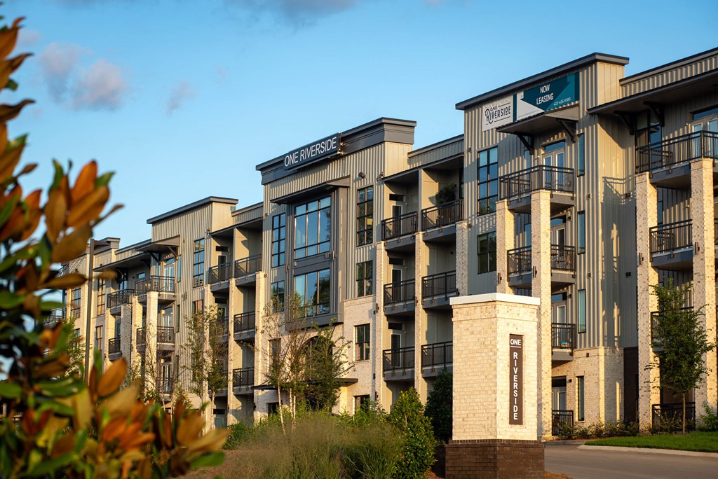 a row of apartment buildings with trees in the foreground  at One Riverside Apartments, Tennessee