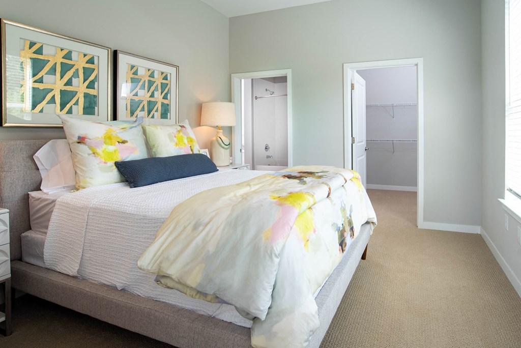 a bedroom with a bed and a door to a closet a bedroom with a bed and a door to a closet at One Riverside Apartments, Chattanooga
