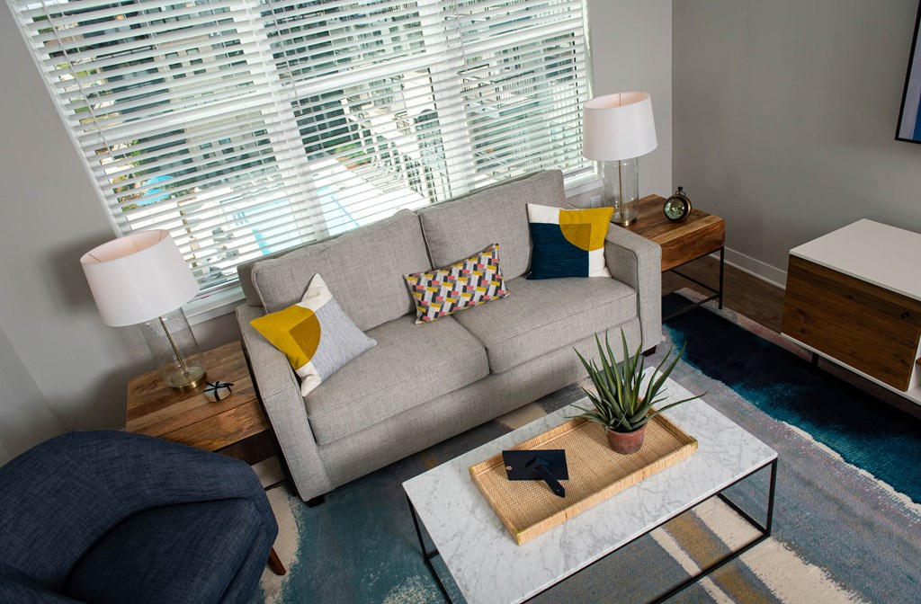 a living room with a couch and a coffee table at One Riverside Apartments, Chattanooga, TN, 37403
