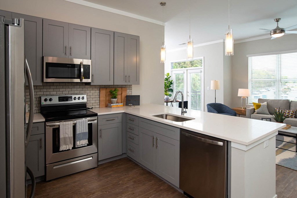 a kitchen with stainless steel appliances and a white counter top at One Riverside Apartments, Chattanooga, 37403