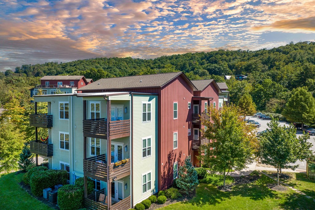 an aerial view of a building with a mountain in the background