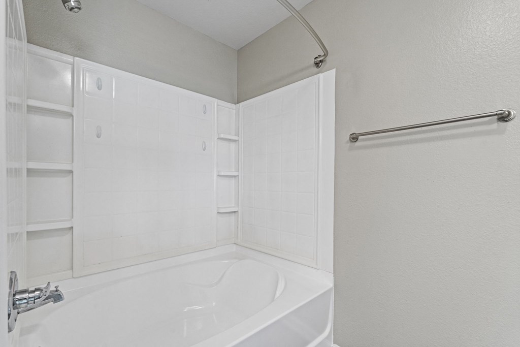 a white bathroom with a tub and shower and a sink at SomerHill Farms Apartments, Virginia
