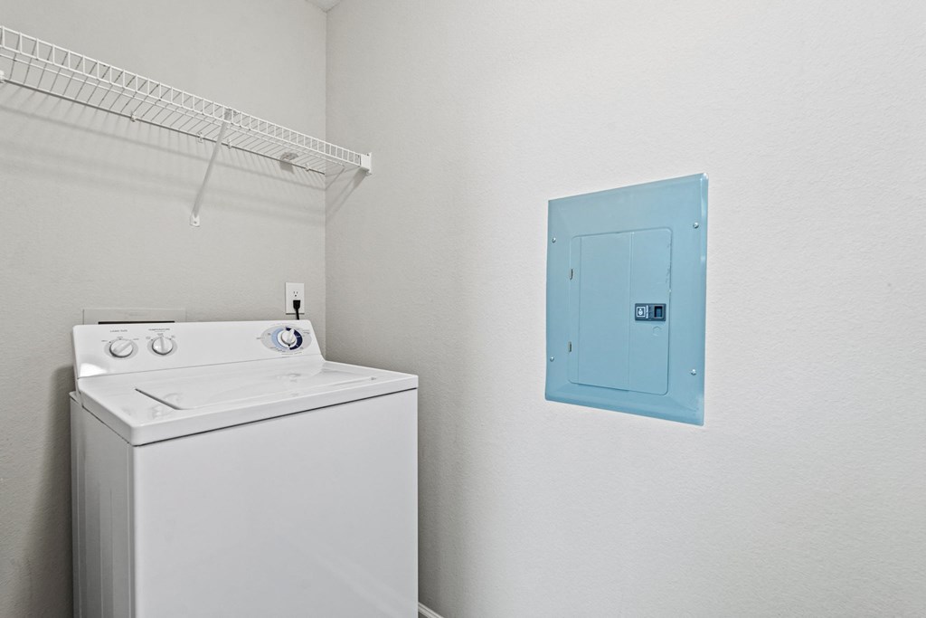 a white washer and dryer in a room with a blue door at SomerHill Farms Apartments, Gainesville, VA 20155