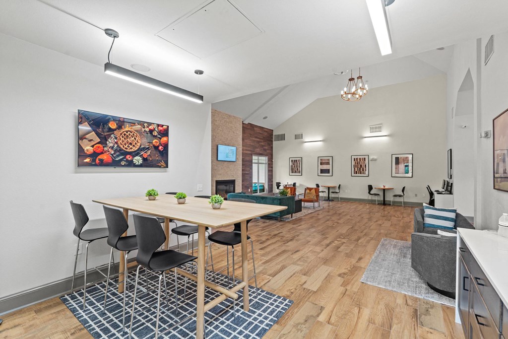 a dining room with a table and chairs and a living room at SomerHill Farms Apartments, Gainesville, 20155