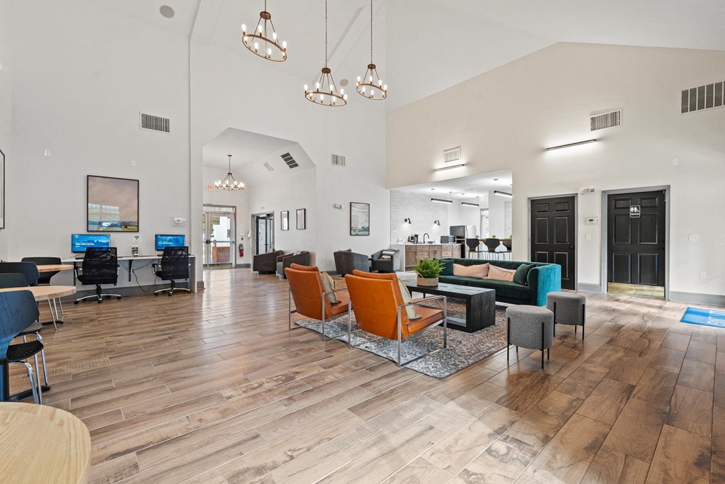 a large lobby with chairs and couches and a reception desk at SomerHill Farms Apartments, Gainesville