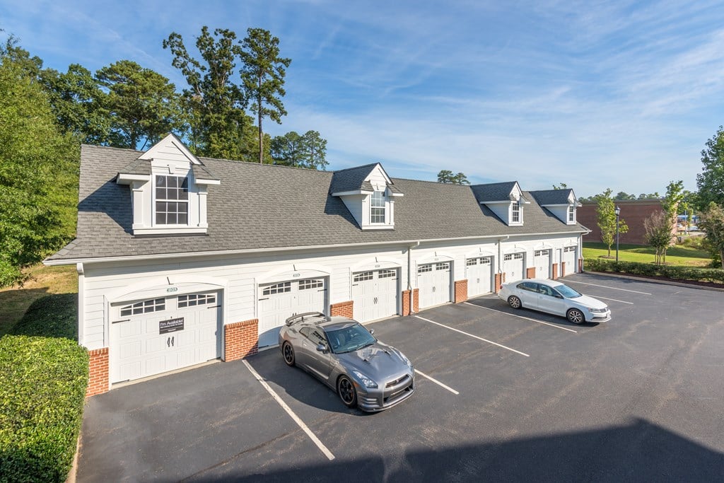 A car is parked in front of a garage  at Sterling Manor, Williamsburg, 23185