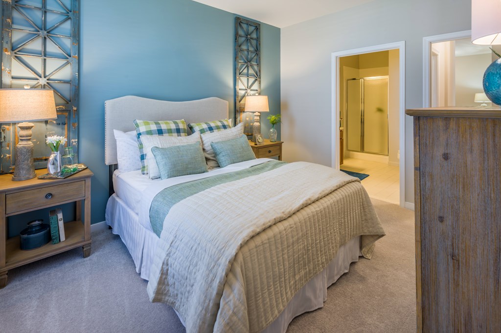 A bedroom with a bed, nightstand, and a wooden cabinet  at Sterling Manor, Williamsburg, 23185