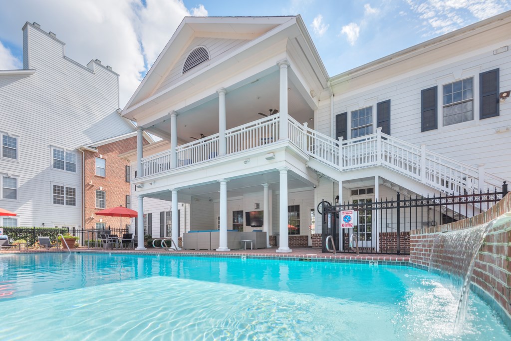 A pool in front of a white house with a balcony  at Sterling Manor, Williamsburg, 23185