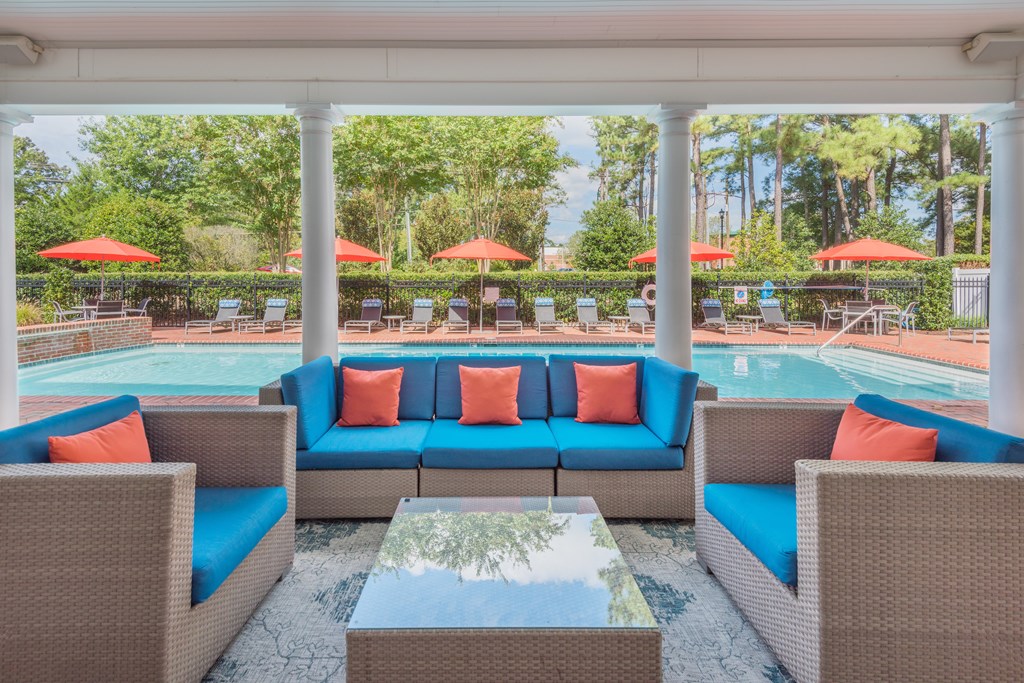 A patio with a pool and a table with chairs  at Sterling Manor, Williamsburg, VA, 23185