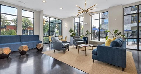 a large living room with blue couches and chairs