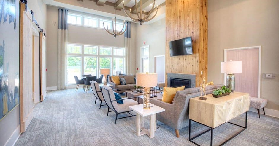 a living room with a bunch of tables and chairs  at Lullwater at Big Ridge, Hixson, TN