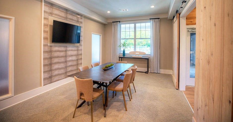 a dining room with a table and chairs and a television a dining room with a table and chairs and a television at Lullwater at Big Ridge, Hixson, Tennessee