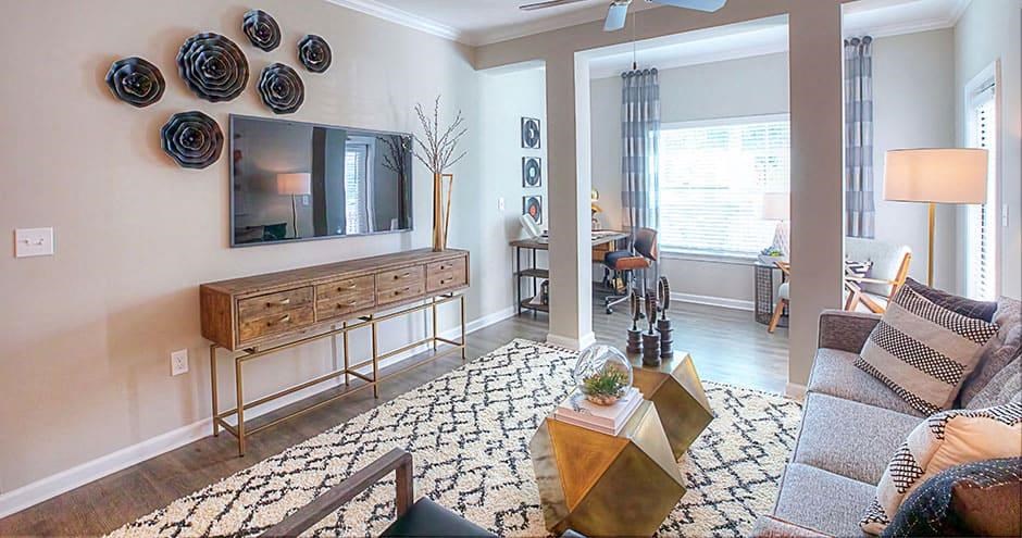 a living room with a couch and a television  at Lullwater at Big Ridge, Hixson, TN, 37343