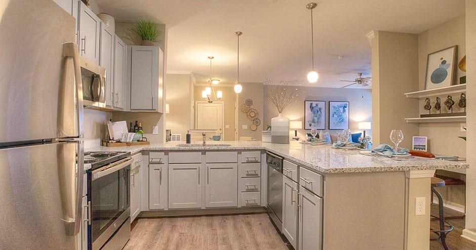 a large kitchen with white cabinets and a counter top  at Lullwater at Big Ridge, Hixson, TN, 37343