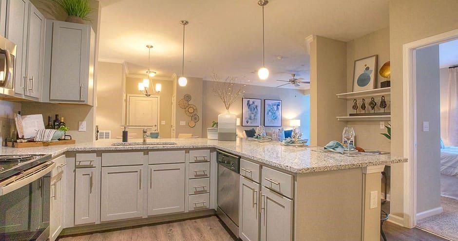 a kitchen with white cabinets and granite counter tops  at Lullwater at Big Ridge, Hixson, TN