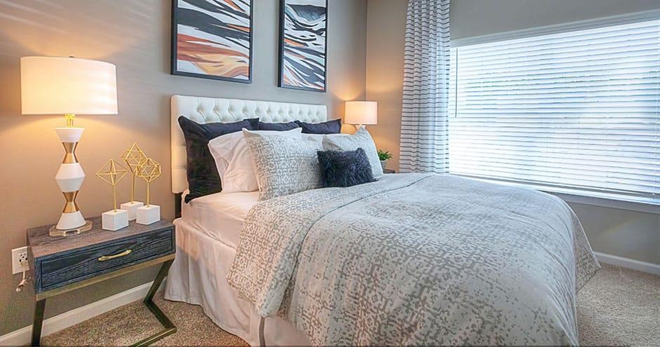 a bedroom with a bed and two lamps  at Lullwater at Big Ridge, Hixson, Tennessee