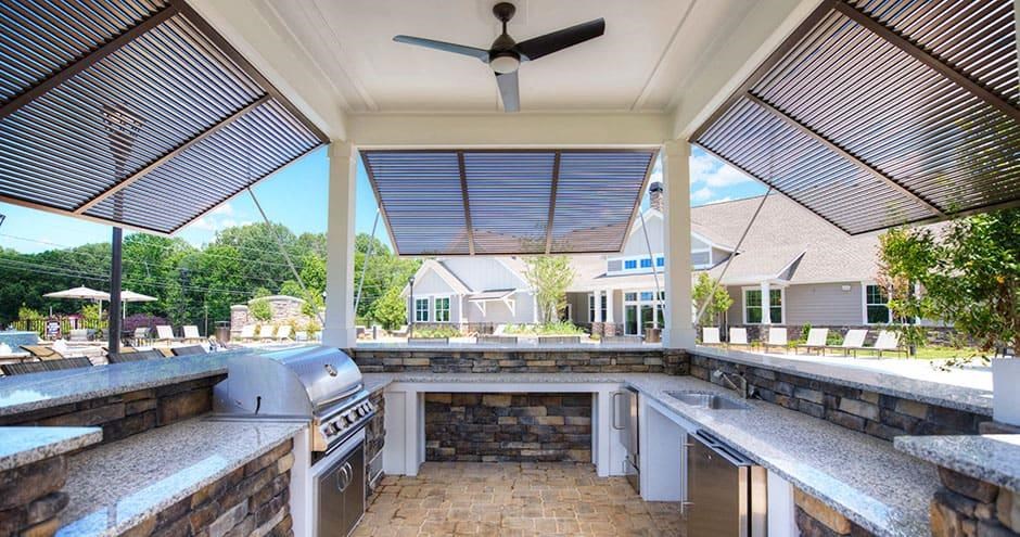 a outdoor kitchen with a grill and a patio  at Lullwater at Big Ridge, Hixson