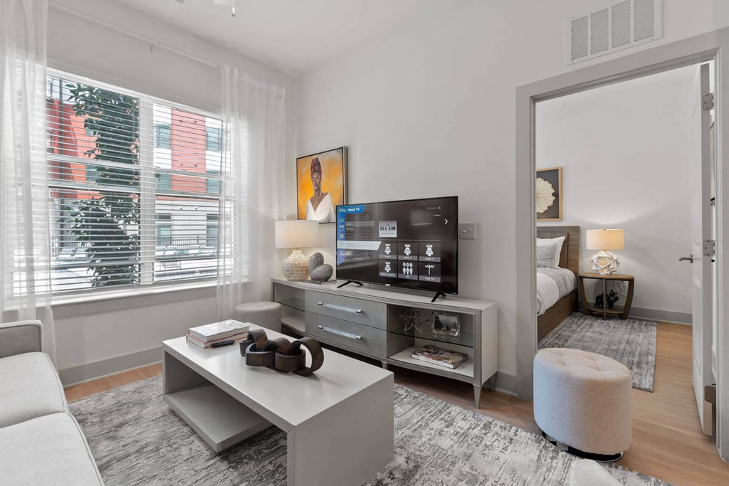 a living room with a large window and a white coffee table at Tapestry West, Virginia