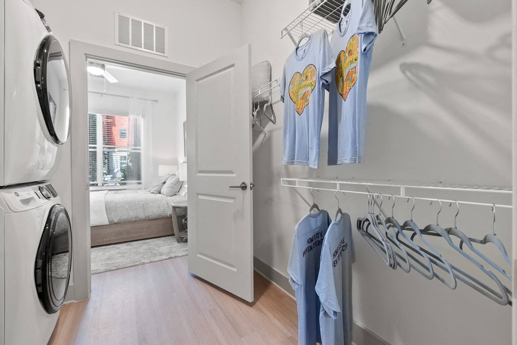 a washer and dryer in a room with a bedroom in the background at Tapestry West, Richmond, VA
