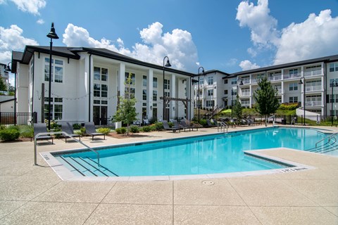 A swimming pool in front of apartment buildings.