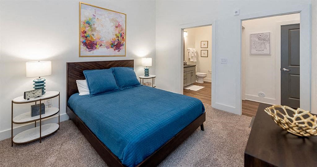 a bedroom with a bed and a door to a bathroom at Livingston Flats Apartments, Chesterfield, VA, 23832