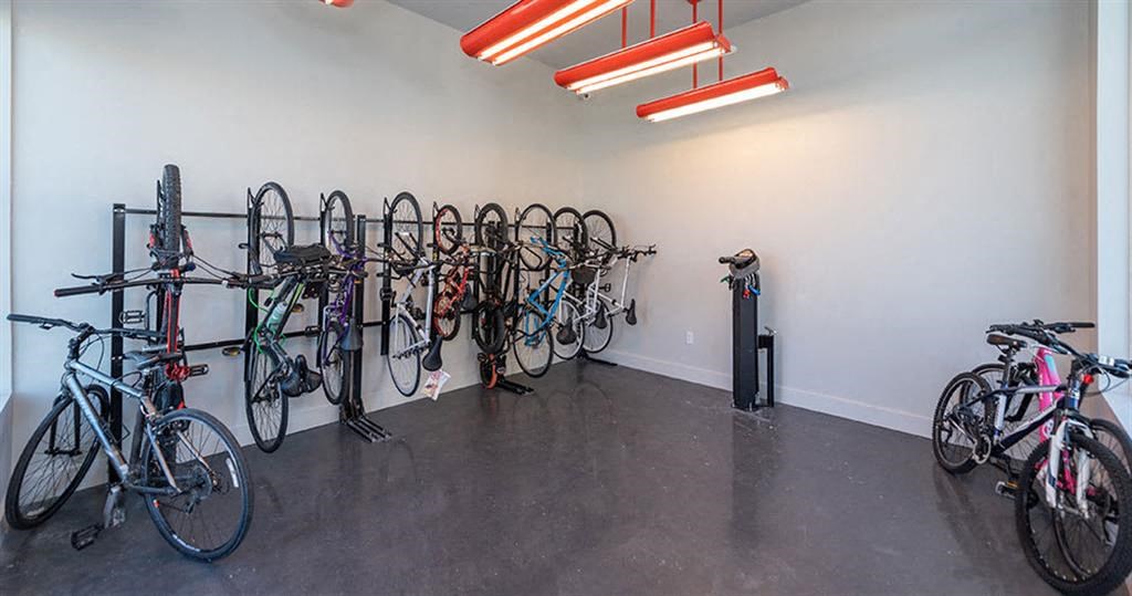 a room filled with lots of bikes on top of a cement floor at Livingston Flats Apartments, Chesterfield, VA, 23832
