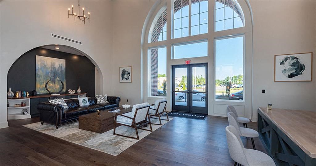 a living room filled with furniture and a large window at Livingston Flats Apartments, Virginia,23832