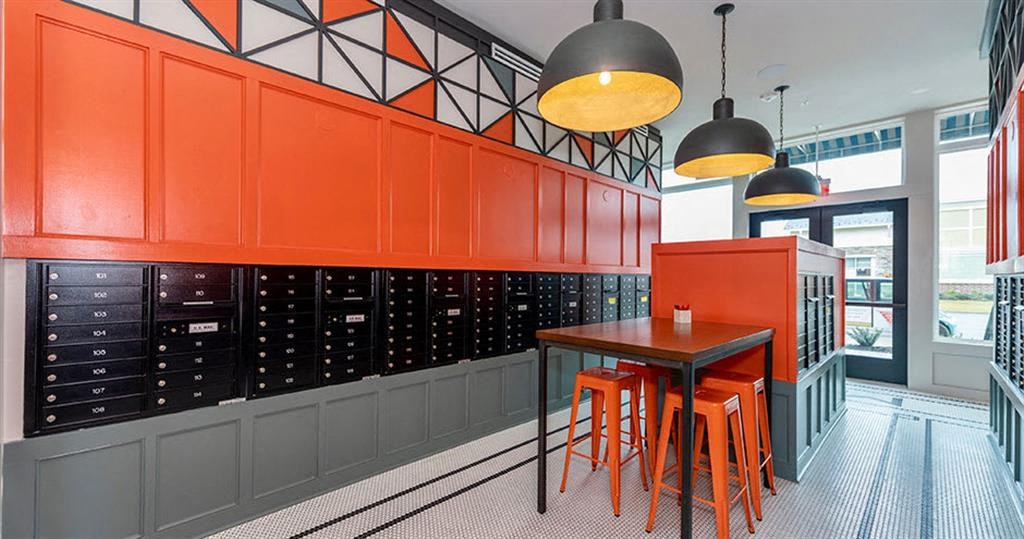 a table and chairs in a room with orange cabinets at Livingston Flats Apartments, Chesterfield