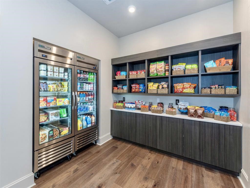 a pantry with two refrigerators and shelves of food at  Livingston Flats Apartments, Virginia