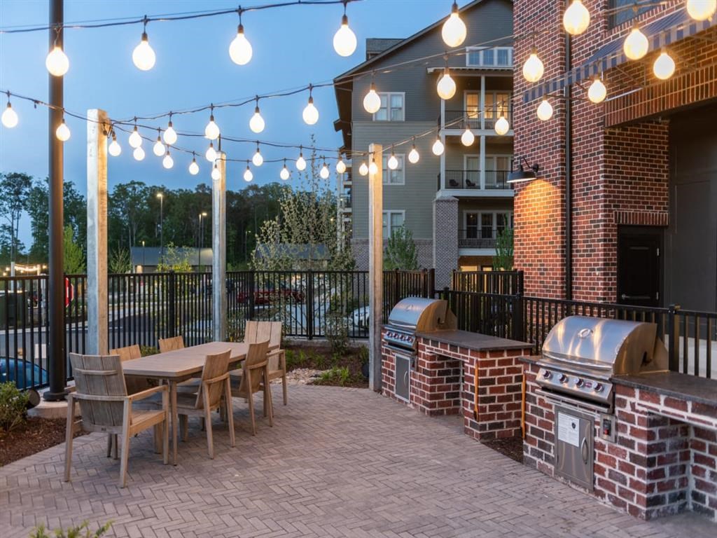 a patio with a grill and a table and chairs at Livingston Flats Apartments, Chesterfield, VA, 23832