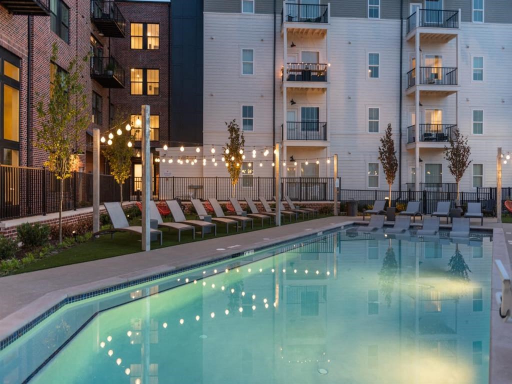 an apartment complex with a pool and lounge chairs at Livingston Flats Apartments, Chesterfield, ,23832