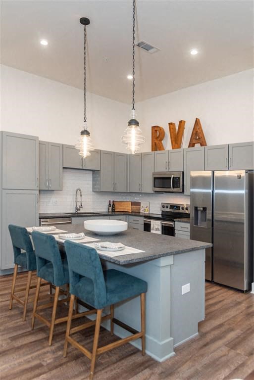a kitchen with a center island and a stove top oven at Livingston Flats Apartments, Chesterfield, VA