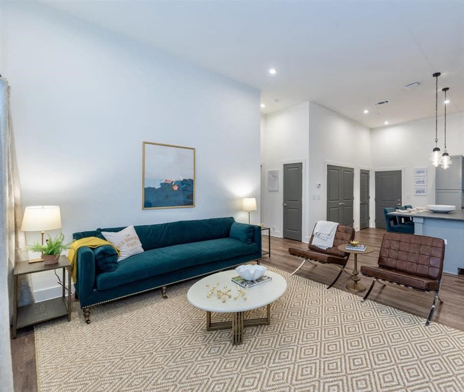 a living room with a blue couch and two chairs at Livingston Flats Apartments, Chesterfield, VA, 23832