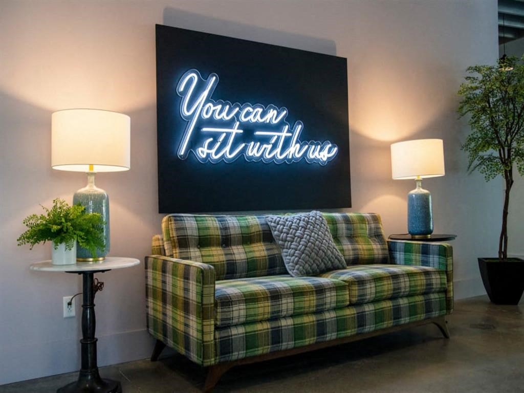 a living room with a couch and a painting on the wall at Flats at West Broad Village, Glen Allen