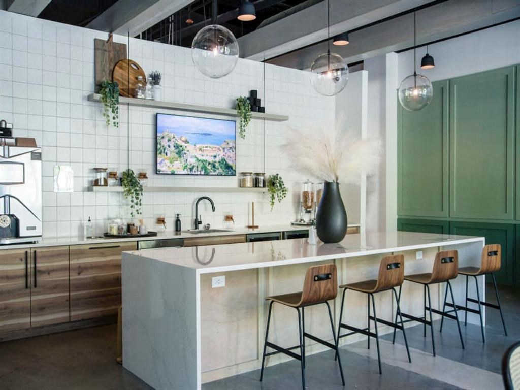 a kitchen with a long counter and a sink at Flats at West Broad Village, Glen Allen, VA