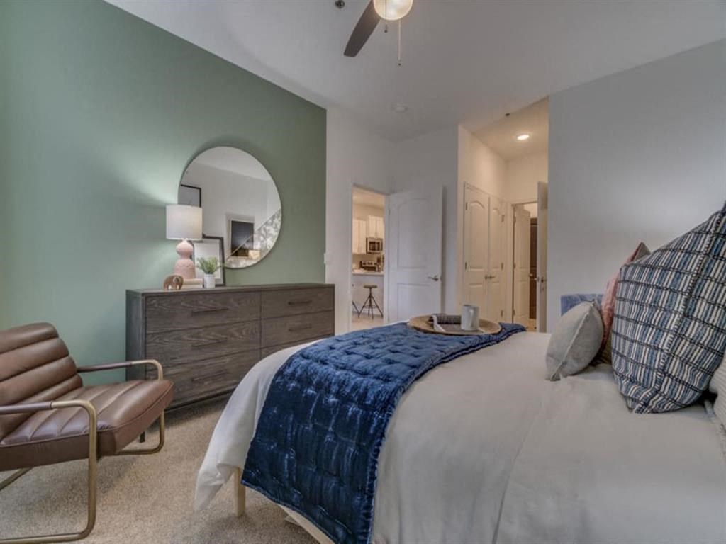 a bedroom with a bed and a ceiling fan a bedroom with a bed and a ceiling fan at Flats at West Broad Village, Virginia, 23060