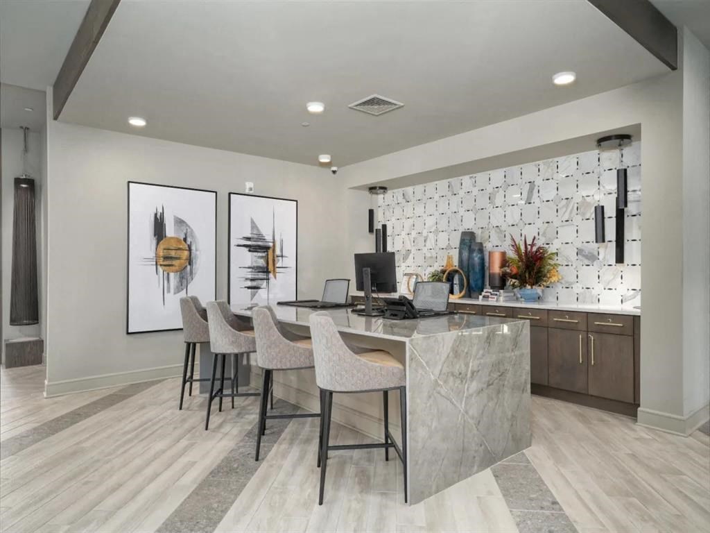 a room with a desk and chairs and a computer on it at Artistry at Winterfield Apartments, Virginia