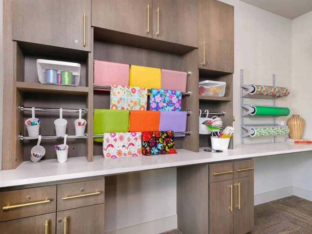 a craft room with wood cabinets and colorful boxes on the shelves at Artistry at Winterfield Apartments, Midlothian, Virginia