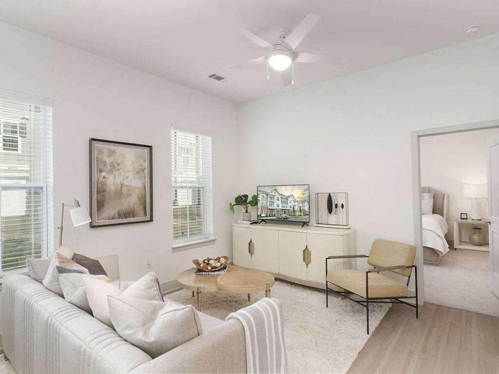 a living room with white walls and a ceiling fan at Artistry at Winterfield Apartments, Midlothian ,23112