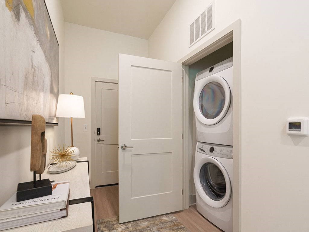 a front load washer and dryer in a laundry room at Artistry at Winterfield Apartments, Midlothian, VA, 23112