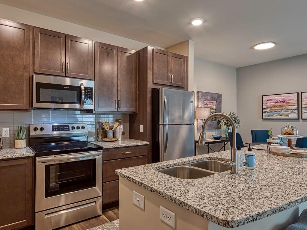 a kitchen with stainless steel appliances and a granite counter top  at Sapphire at Centerpointe, Virginia, 23114