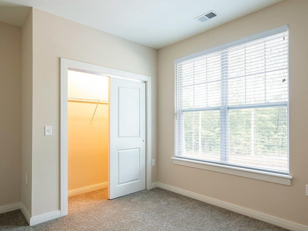 a bedroom with a large window and a closet  at Sapphire at Centerpointe, Midlothian, VA