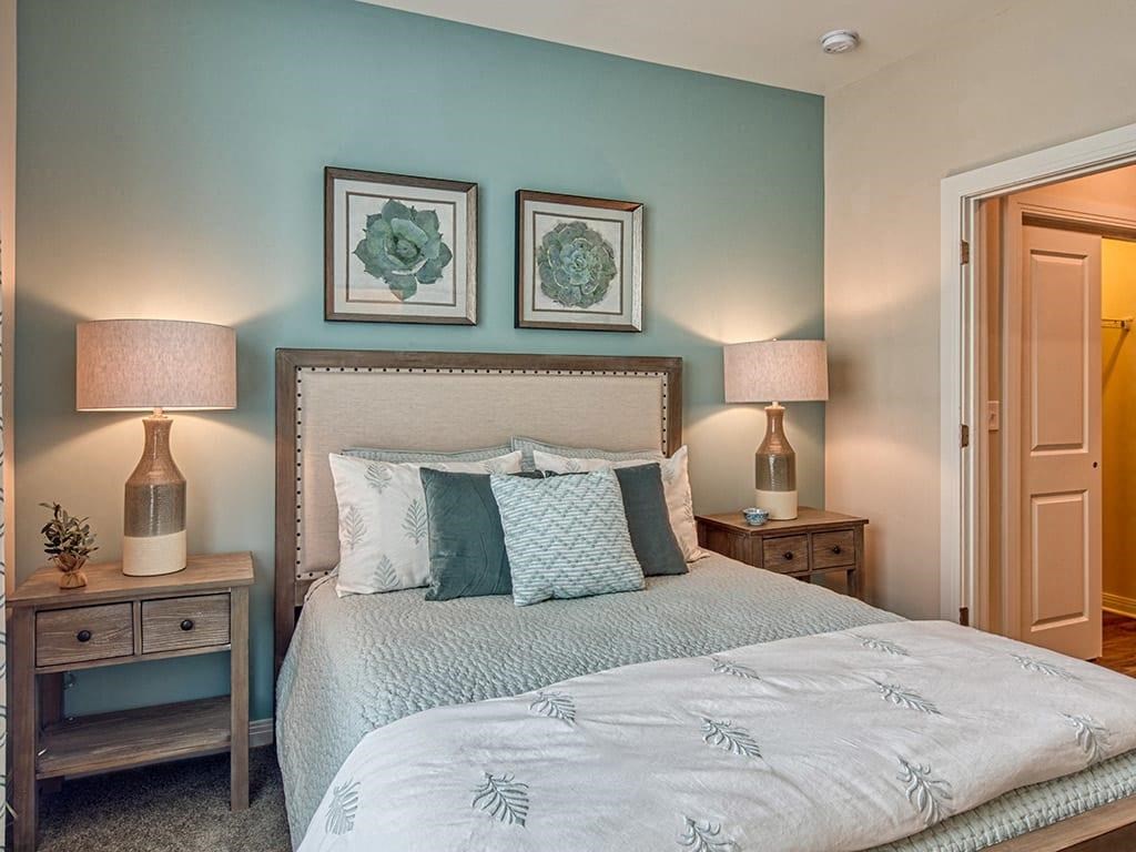 a bedroom with a bed and two night stands with lamps  at Sapphire at Centerpointe, Midlothian, Virginia
