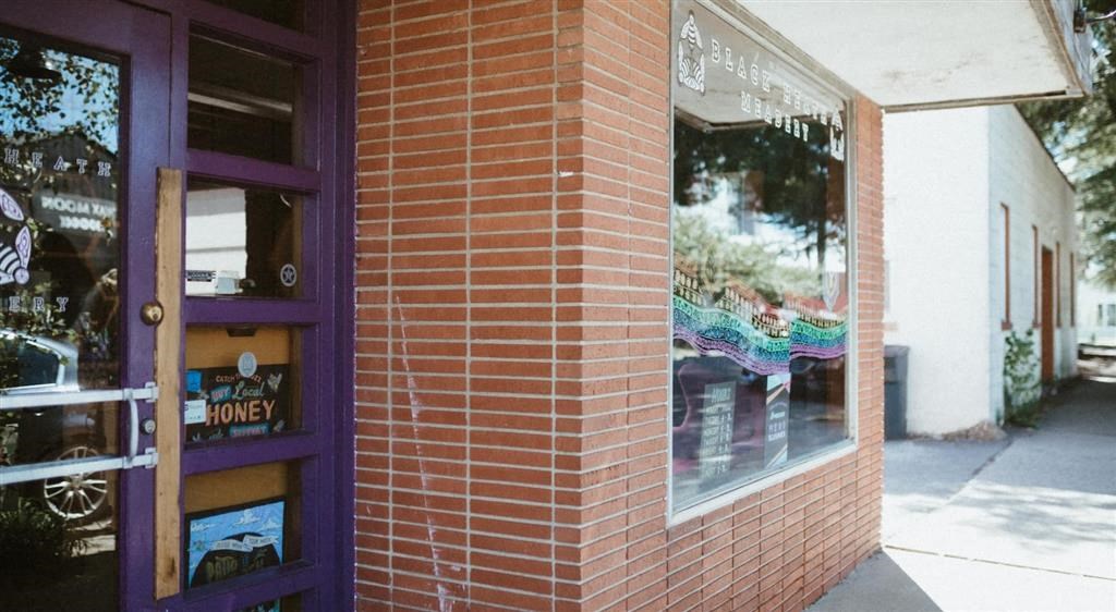a brick building with a purple door
