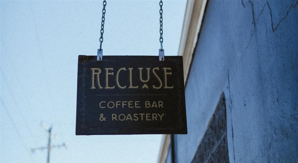 a sign hanging from the side of a building