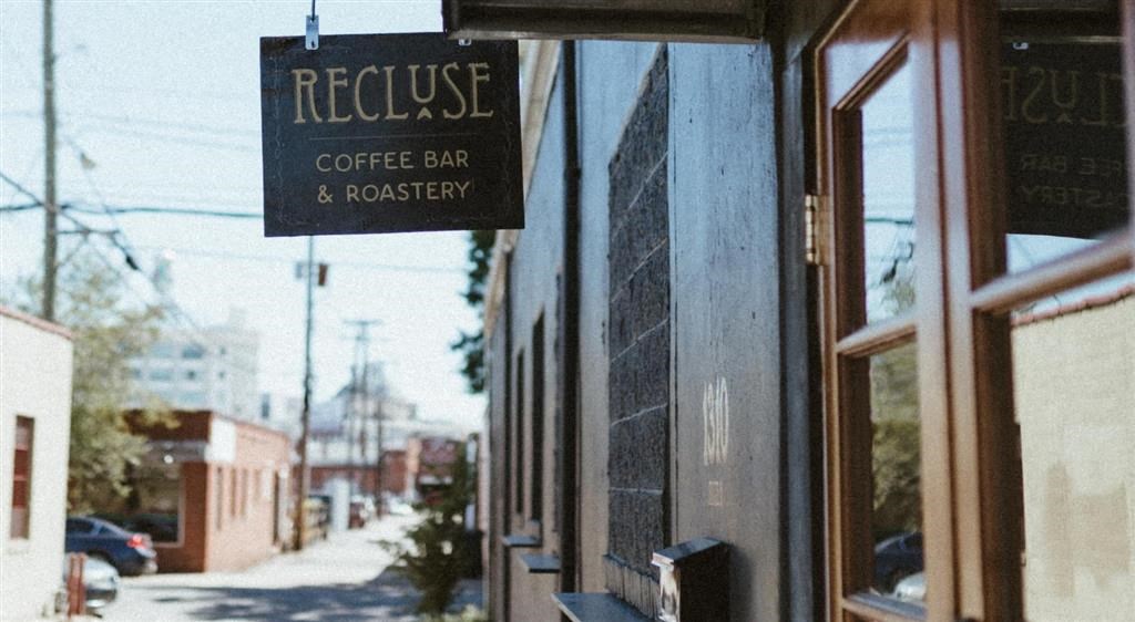 a sign hanging from the side of a building