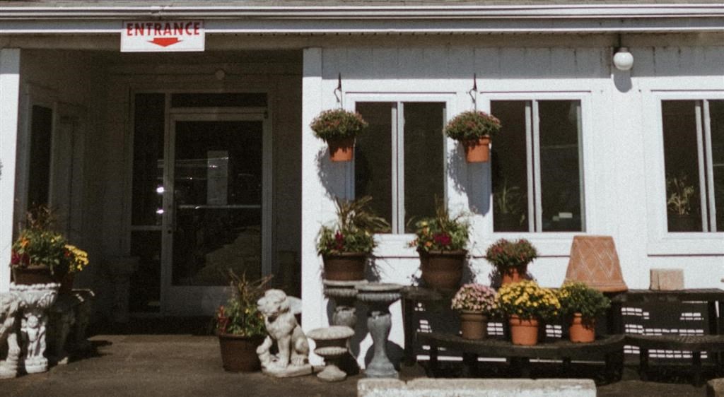 a building with several potted plants in front of it