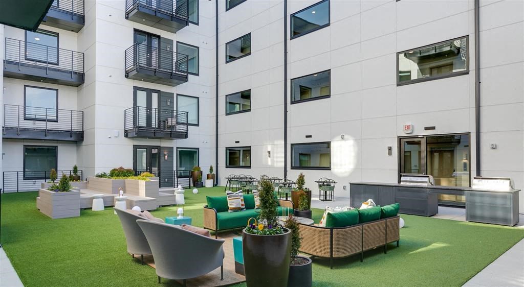 our apartments showcase an indooroopilly lounge with seating and a fire pit
