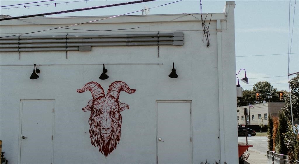 a mural of a goat on the side of a building
